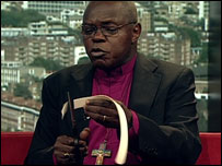 Archbishop of York cutting up his dog collar in Mugabe protest