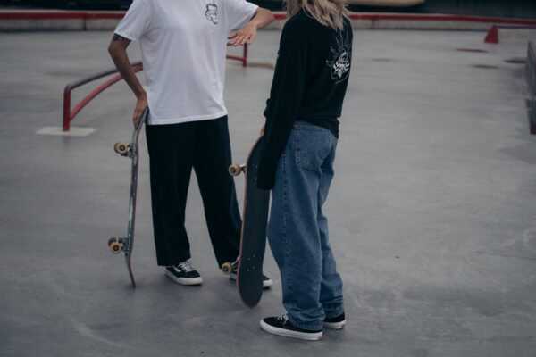 teenagers at skatepark holding skateboards